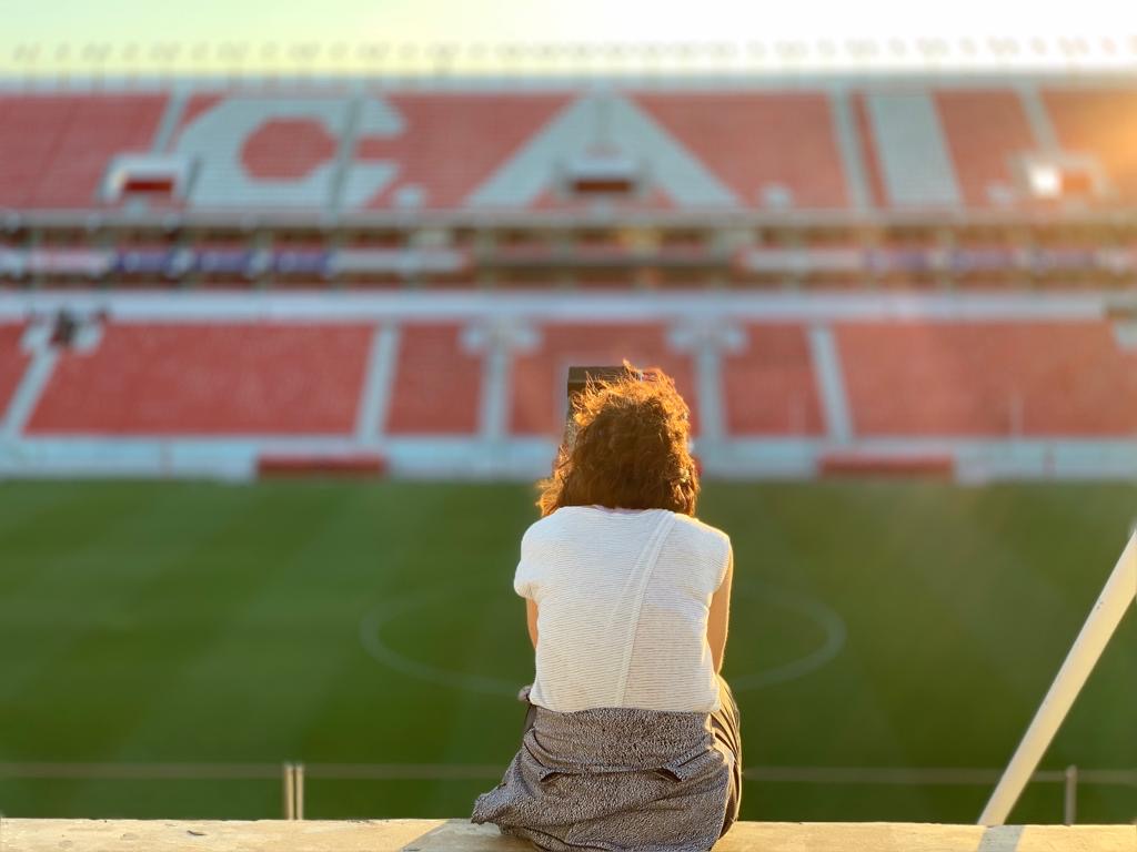 Tracy Wholf in an Argentine soccer stadium at sunset — ESPN investigative field work