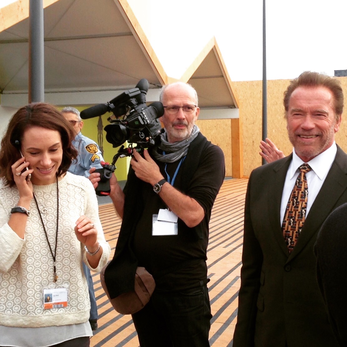 Tracy Wholf on the phone with Arnold Schwarzenegger and camera crew at COP21 in Paris — National Geographic Years of Living Dangerously