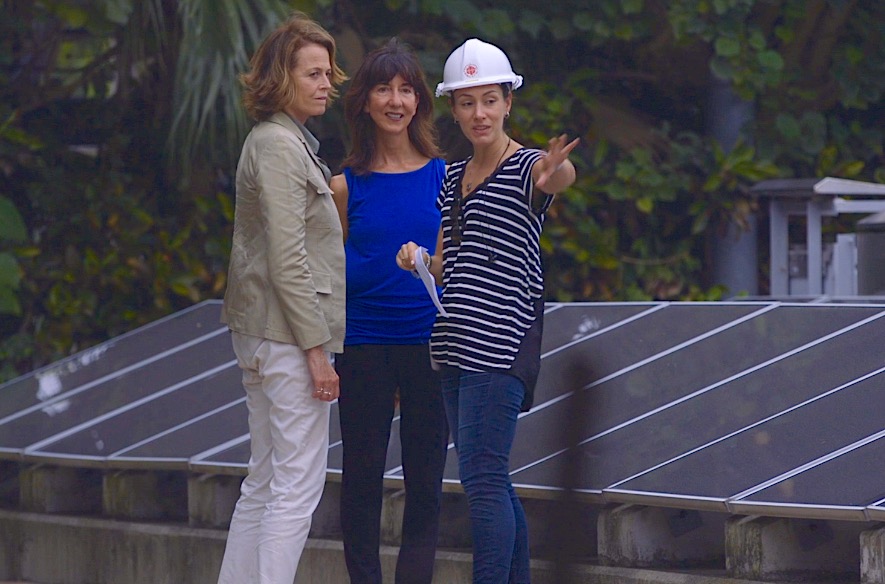 Tracy Wholf with Sigourney Weaver on a solar panel rooftop for National Geographic