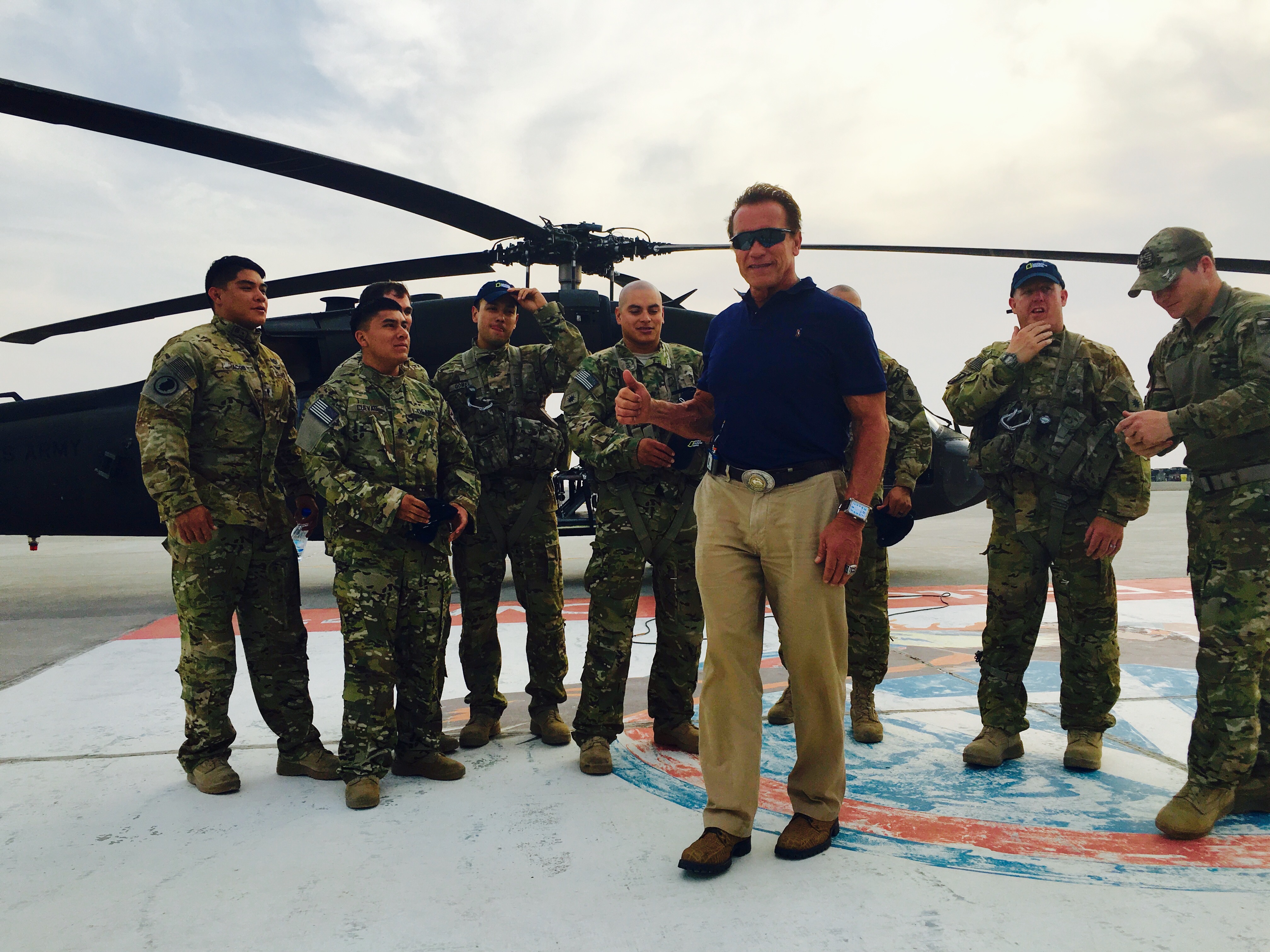 Arnold Schwarzenegger with U.S. soldiers on a military helipad in Kuwait — National Geographic Years of Living Dangerously